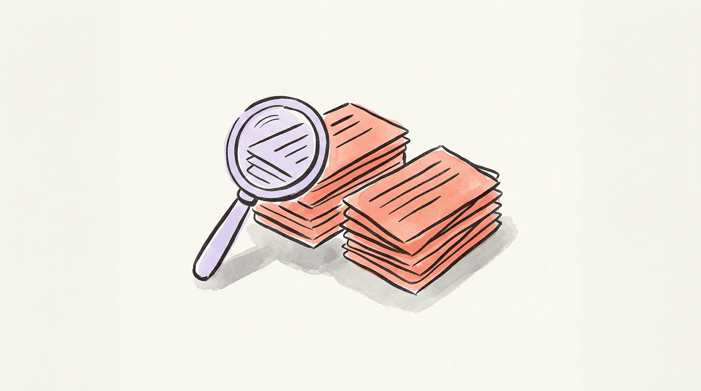 Two stacks of index cards beside a magnifying glass